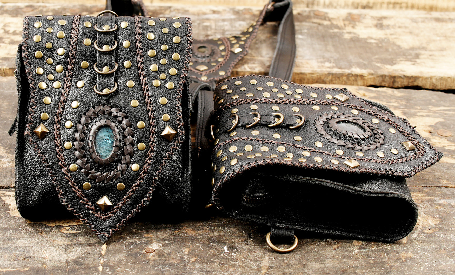 “Gothic-style black leather holster with gemstone medallions and adjustable straps”