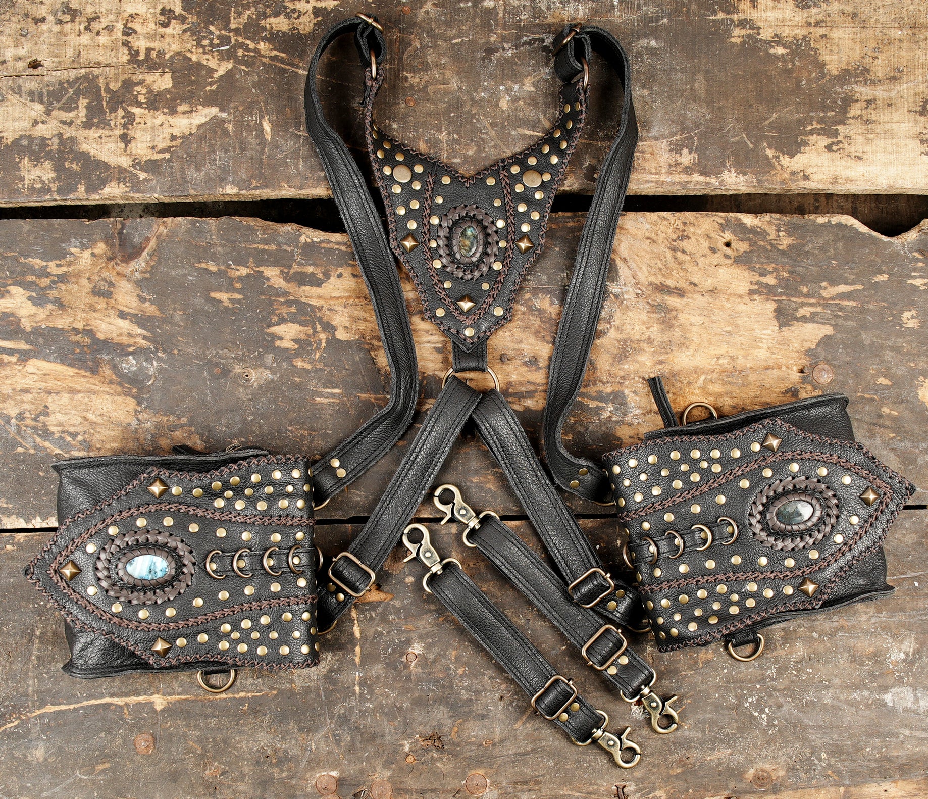 “Black leather bag holster with braided edging and studded detailing”