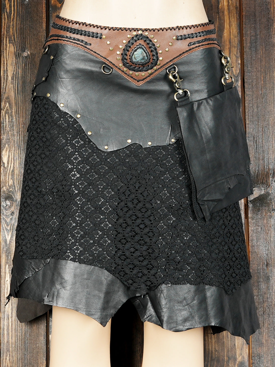 Cowboy-style black leather skirt with lace and gemstone embellishment
