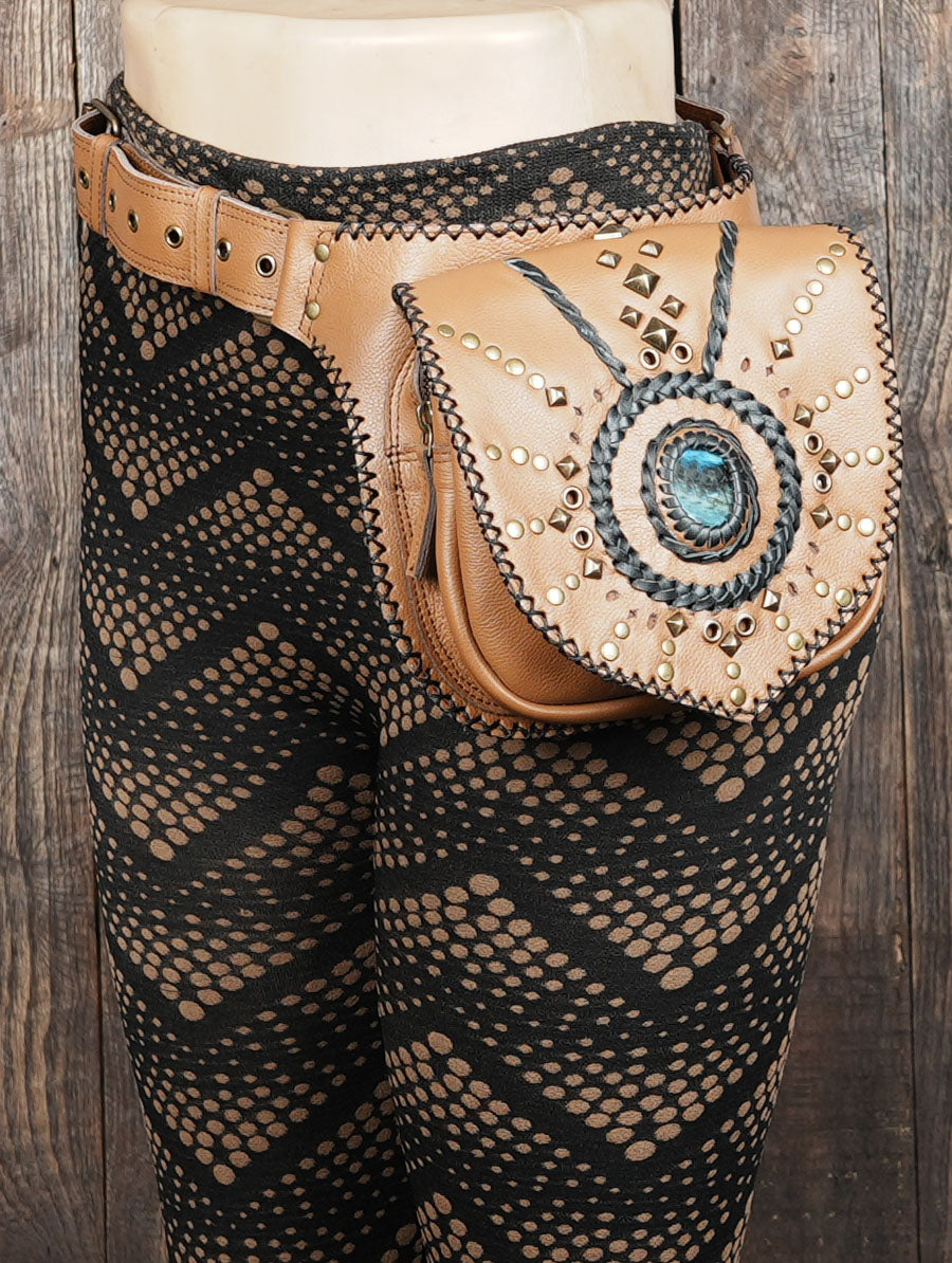 Detailed view of boho-chic leather waist bag with metal rivets