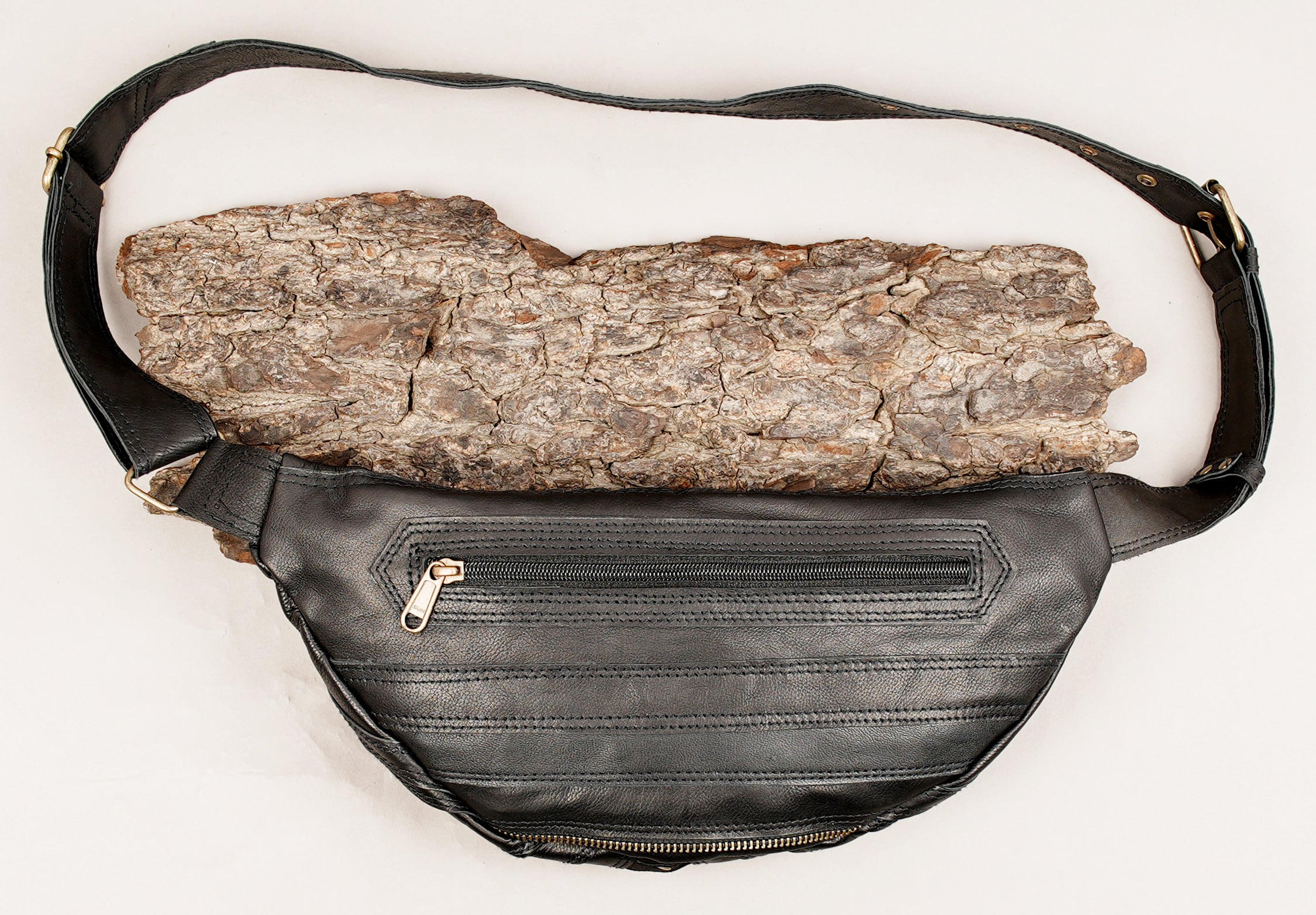 Boho festival leather bag with zipper closure and metallic stud details.