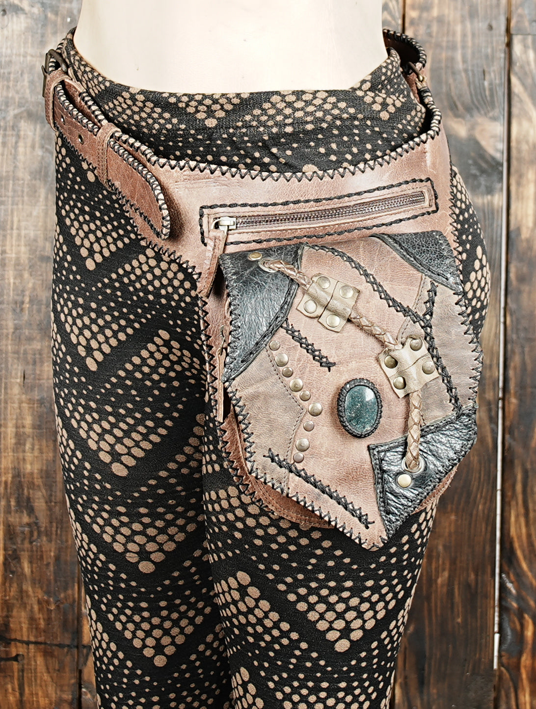 Steampunk-inspired leather belt bag with gemstone and hand stitching