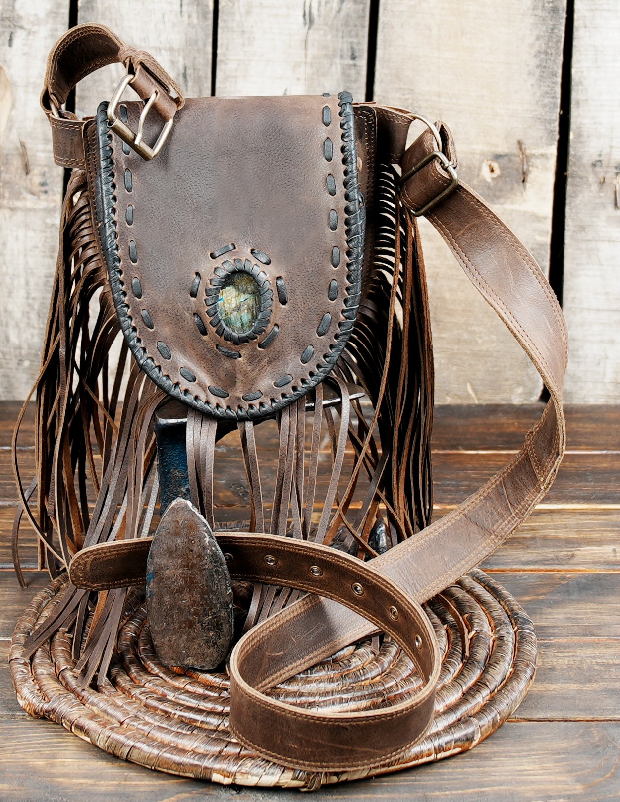 Rustic handmade leather waist bag with fringe and stone accent