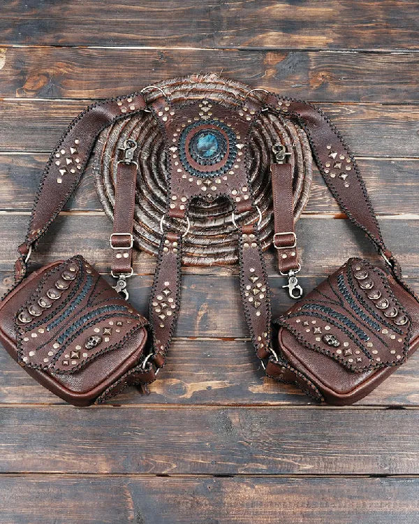 Brown leather belt bag with decorative elements on a wooden surface