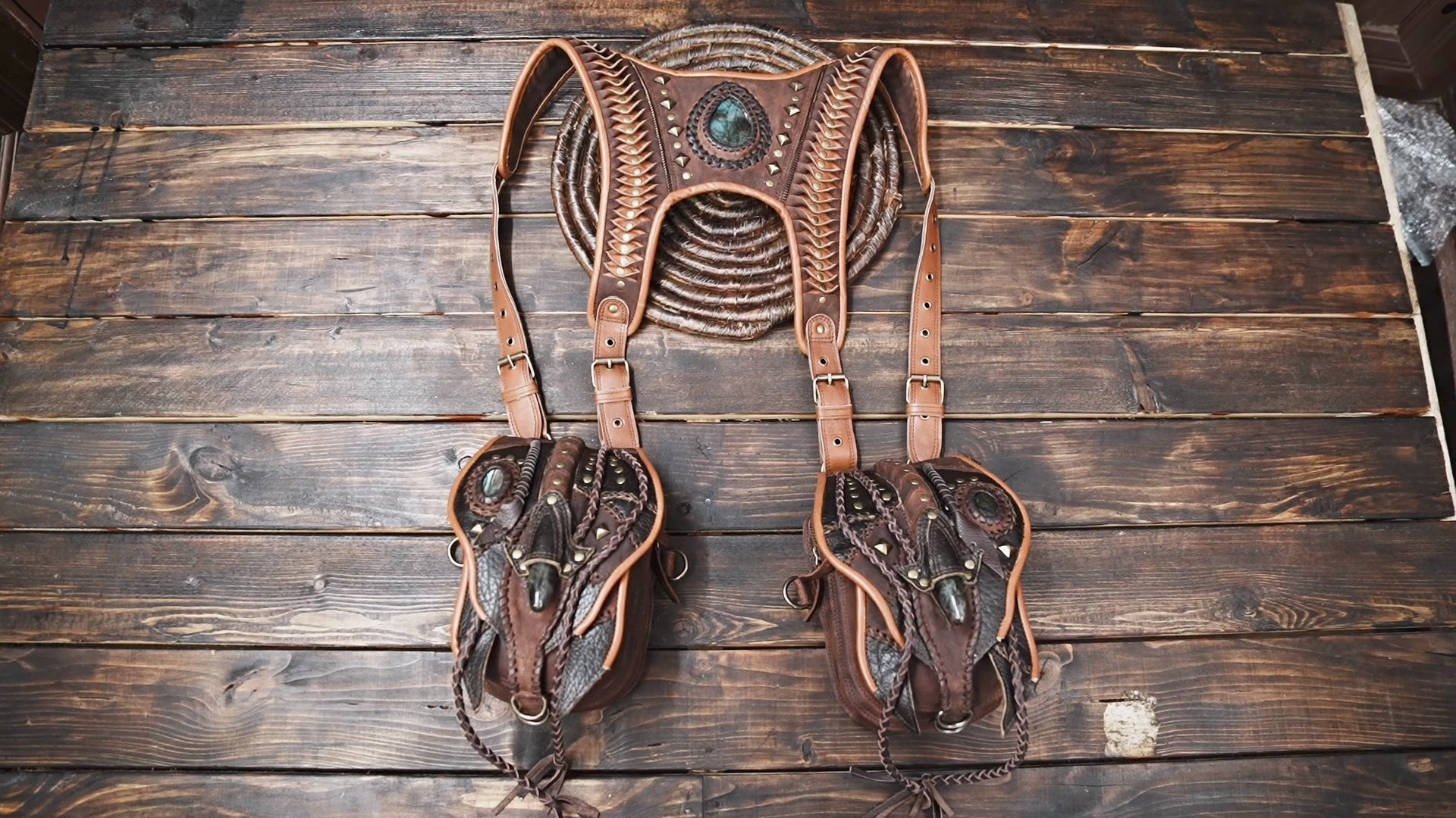 artisan leather harness bag with decorative stitching and medals