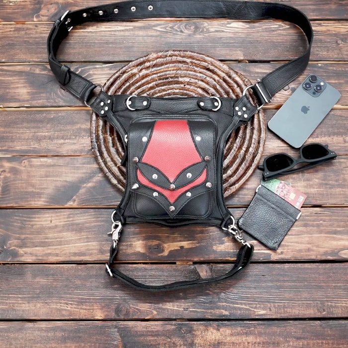Close-up of handmade gothic leather thigh pouch with red panel design