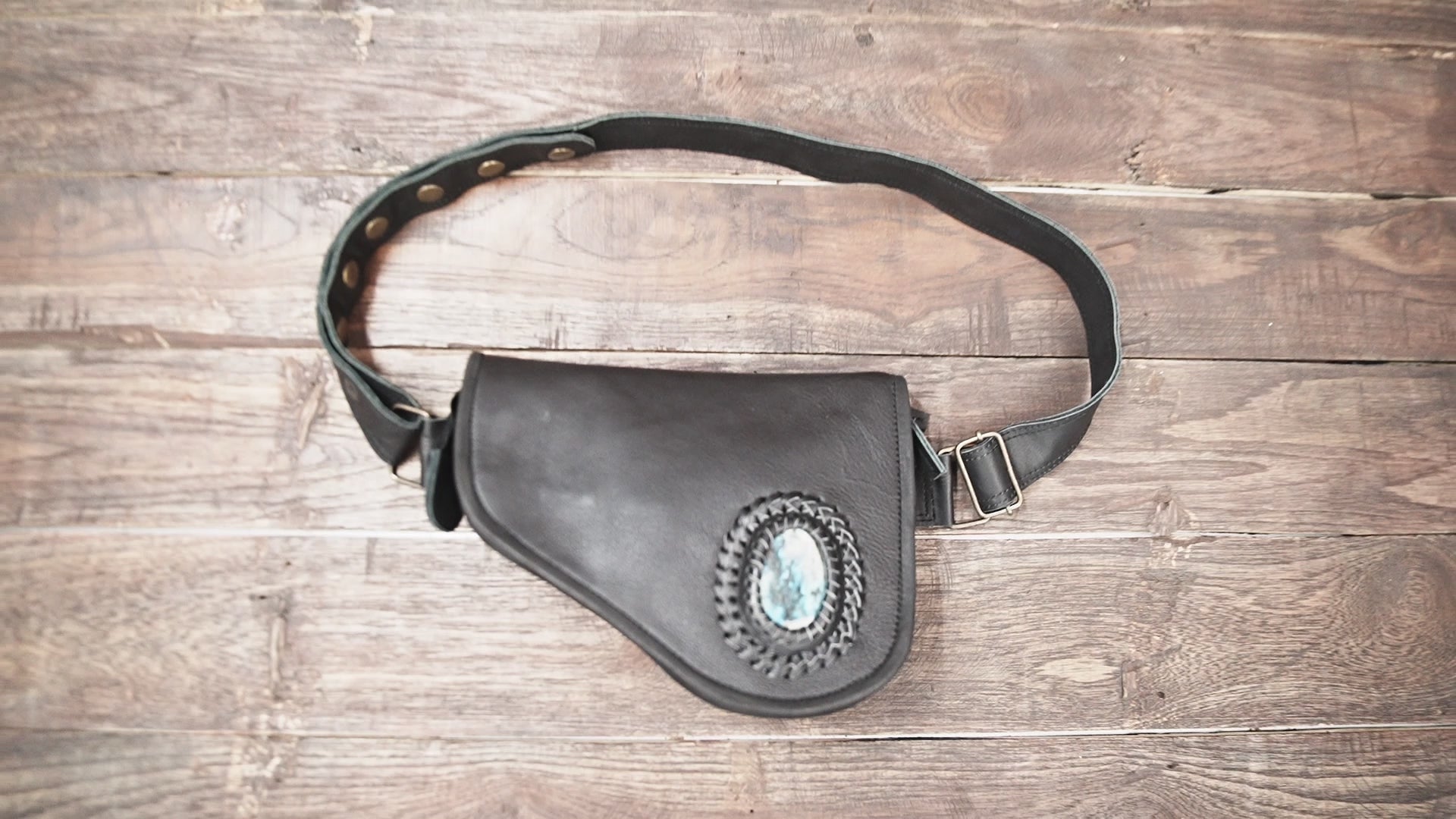 Unisex leather waist pouch with gemstone worn at festival