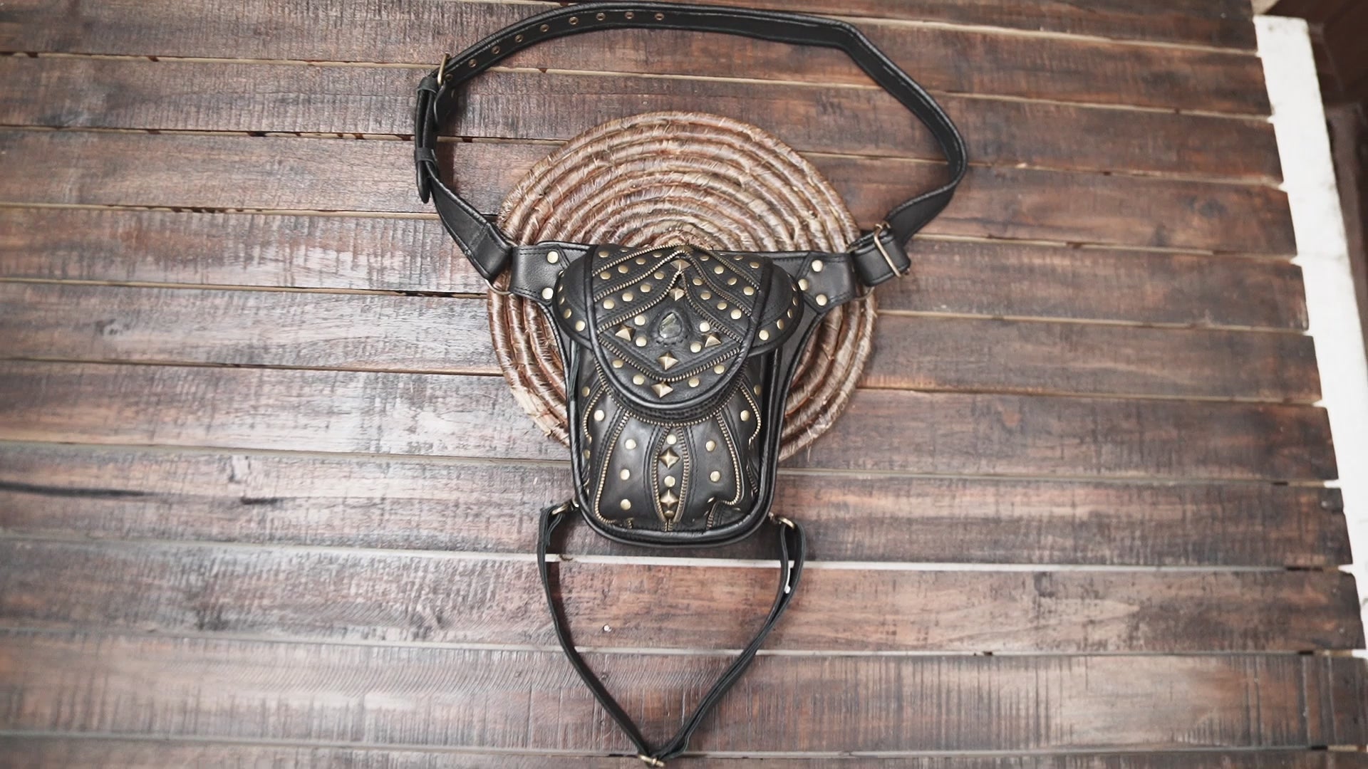 black leather holster belt bag with gold studs and gemstone centerpiece