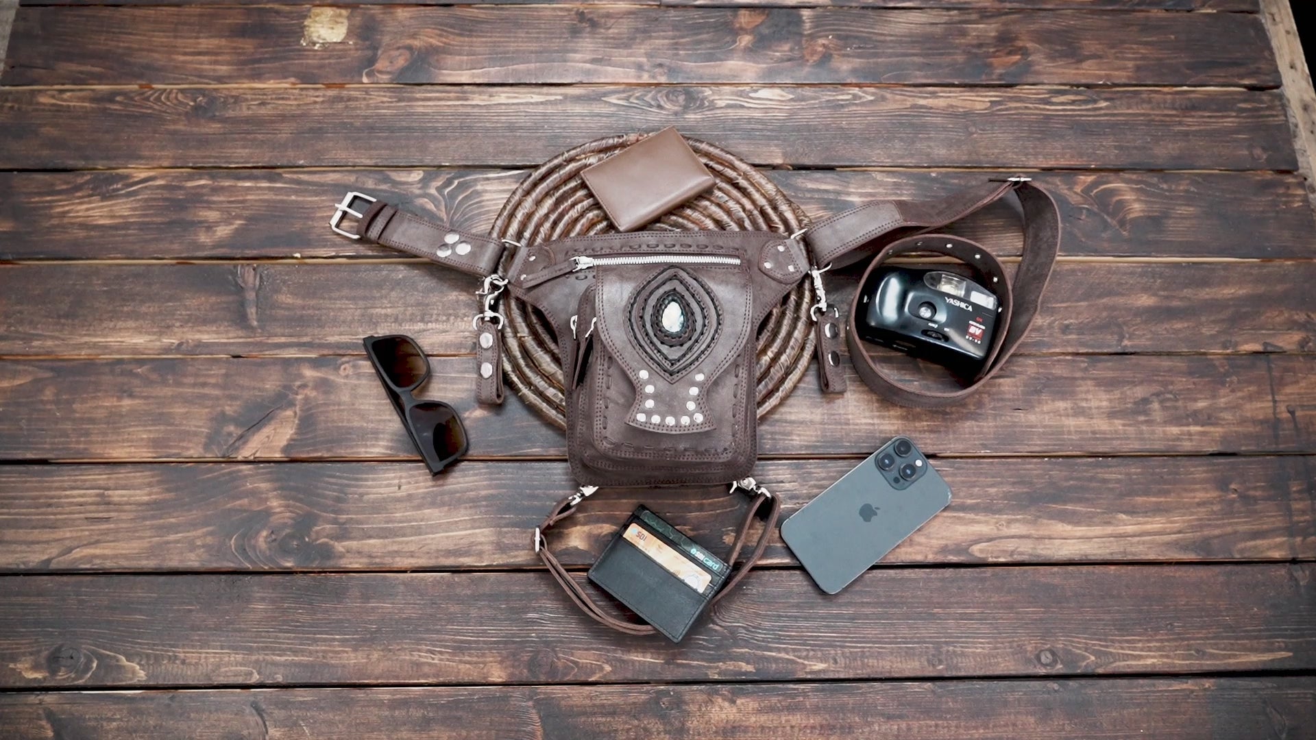 Brown leather hip bag with tribal design and rivet details