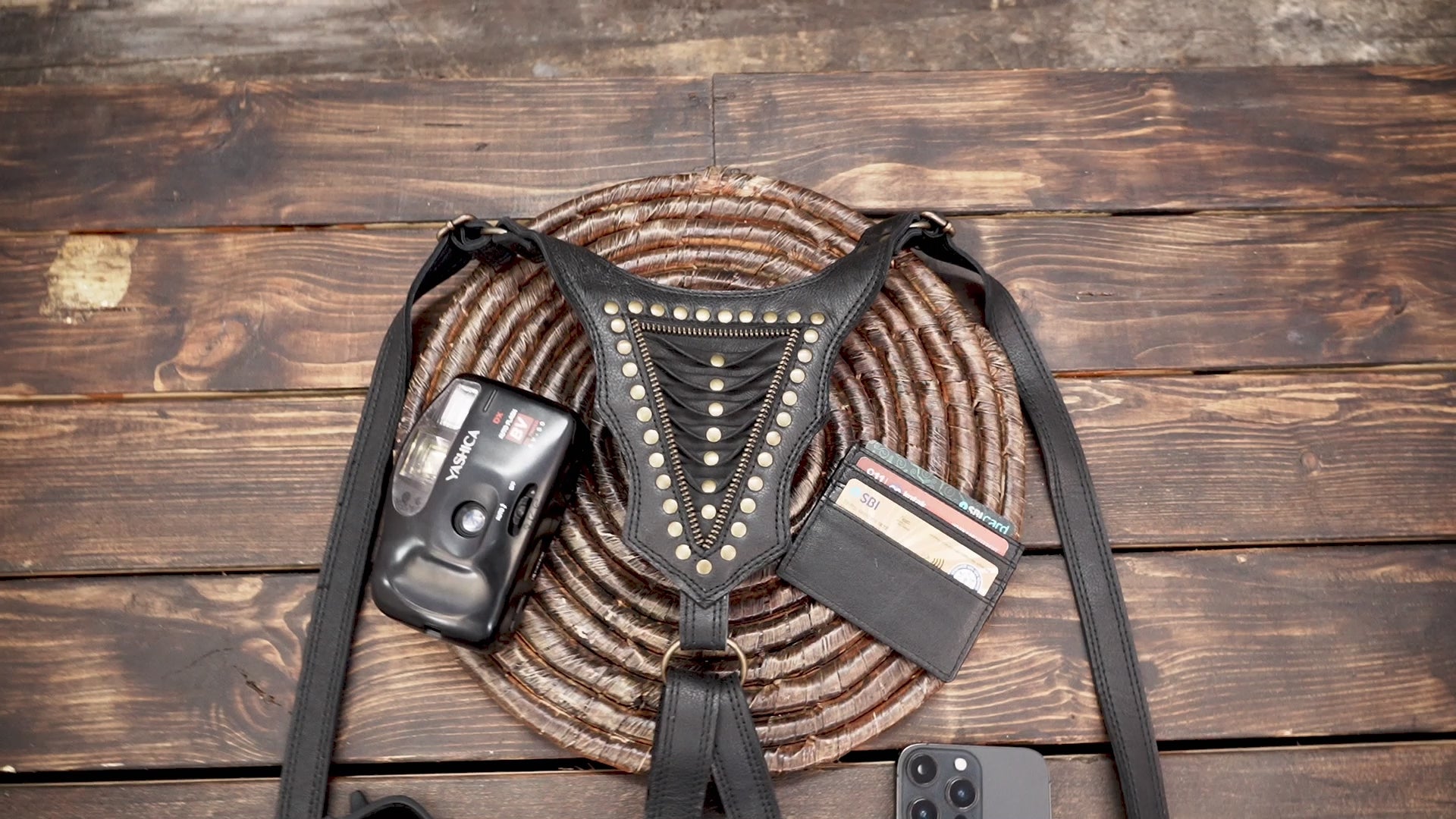 “Handmade dual pouch leather holster with zipper closures and metal studs”