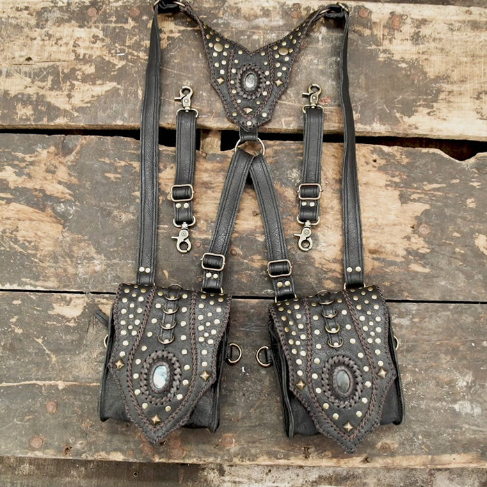 “Black leather festival holster with brass studs and decorative stone inlays”