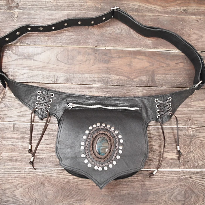 Artisan black leather hip pouch featuring gemstone detail and metallic studs.