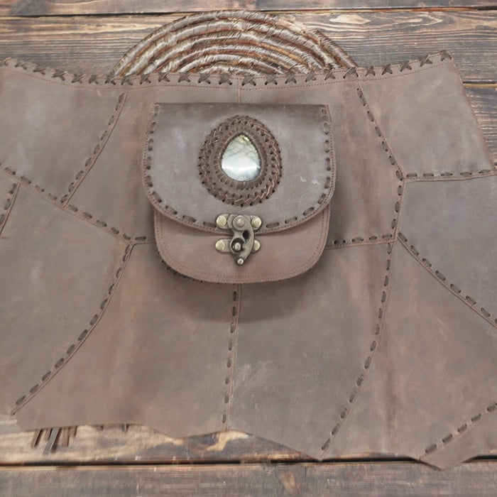 Crafted from soft brown leather with rustic stitching details.