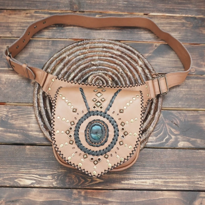 Handmade tan leather fanny pack with decorative studs and stone accent