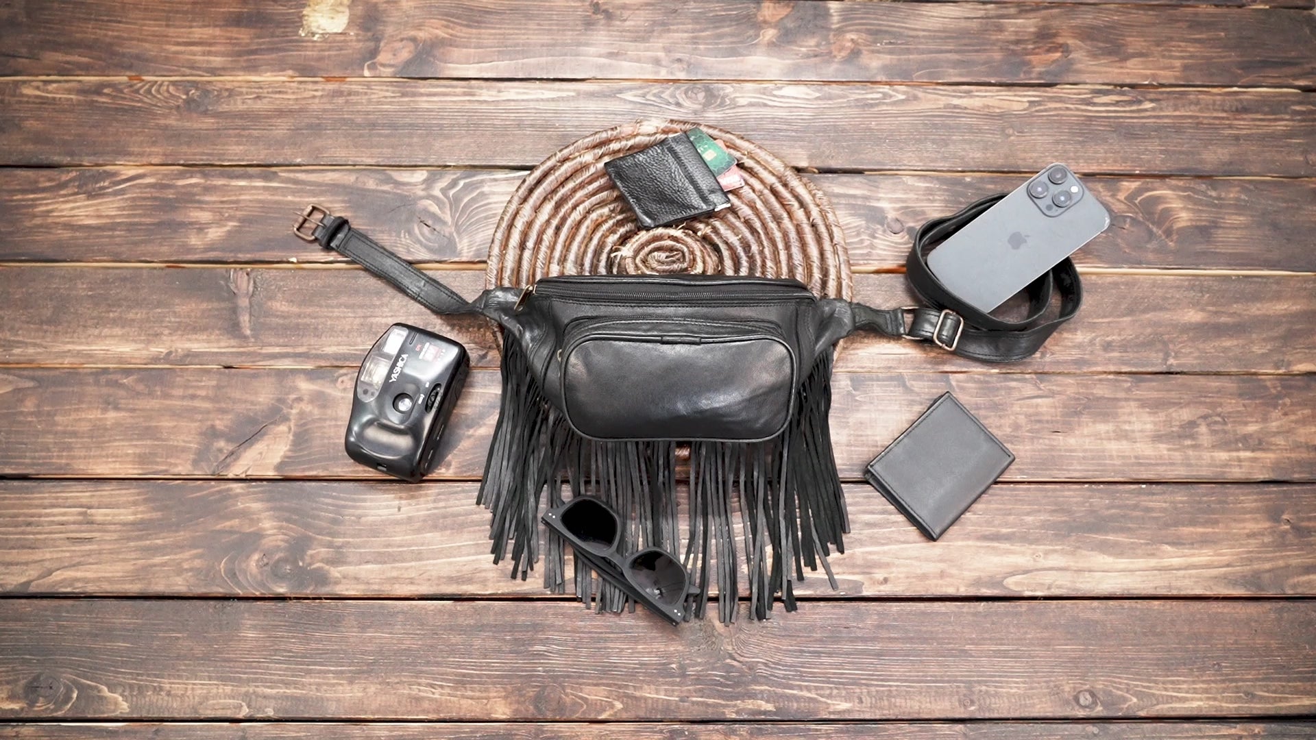Festival style black leather fanny pack with fringe details
