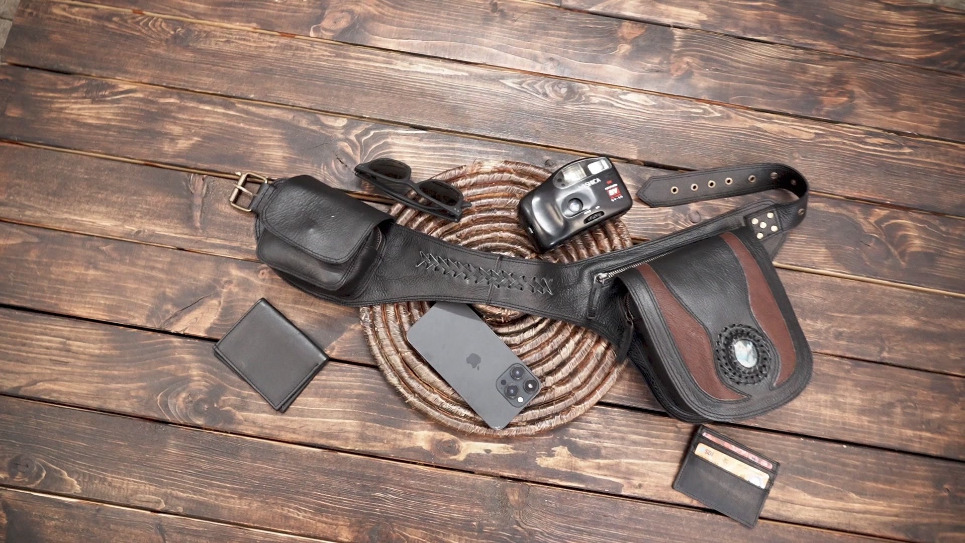 Close-up of gemstone detail on black leather hip bag