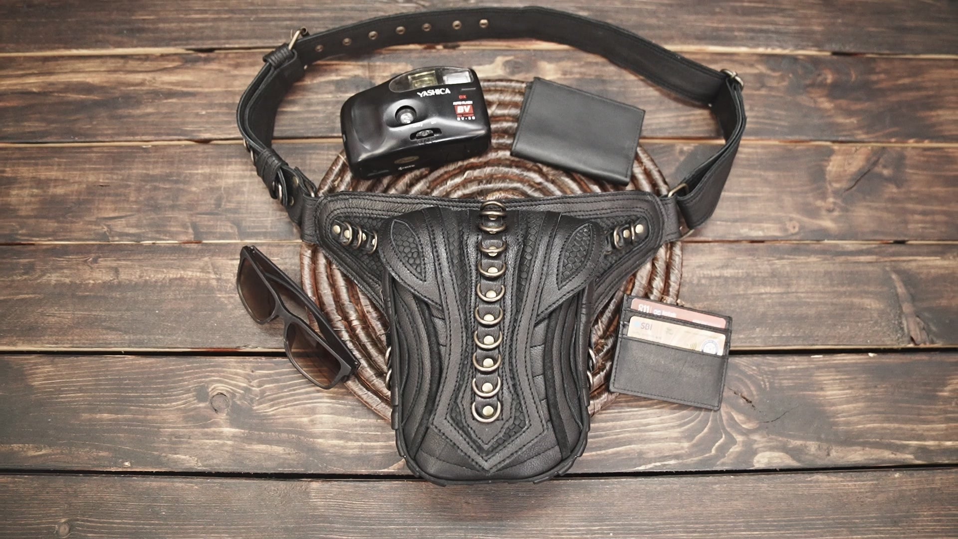Close-up of handcrafted black leather hip pouch with brass hardware