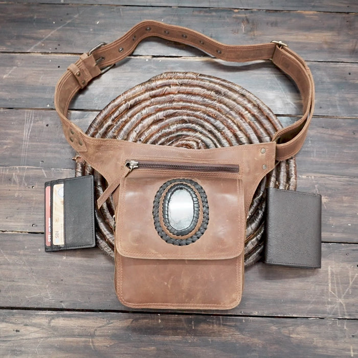 Close-up of leather hip pouch featuring oval labradorite stone centerpiece
