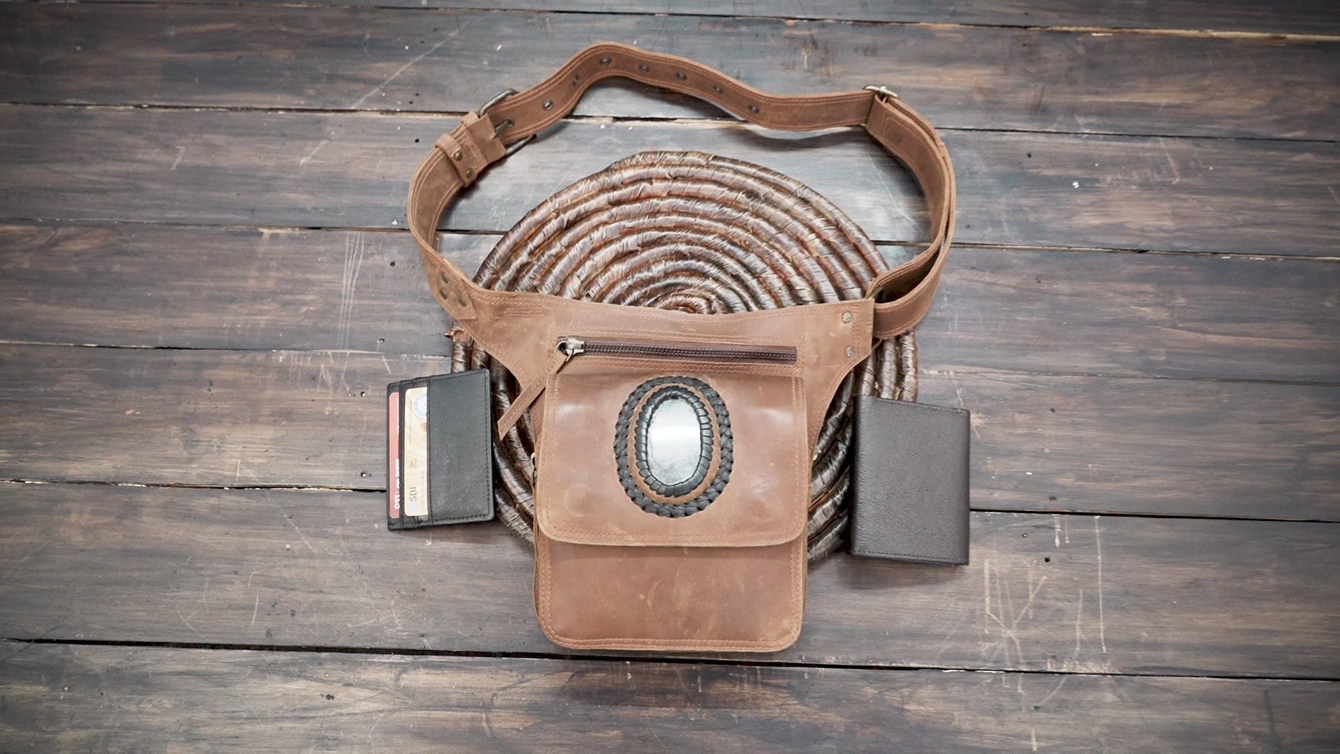 Close-up of leather hip pouch featuring oval labradorite stone centerpiece